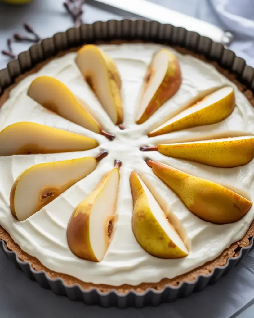Fanned pear halves pressed into frangipane before baking - pat them dry first