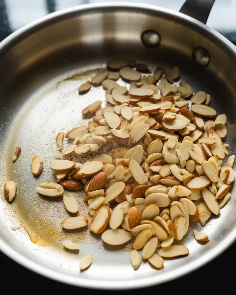 Toasting sliced almonds until golden and fragrant - watch closely to avoid burning
